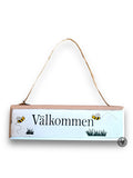 Hängande skylt "Välkommen"